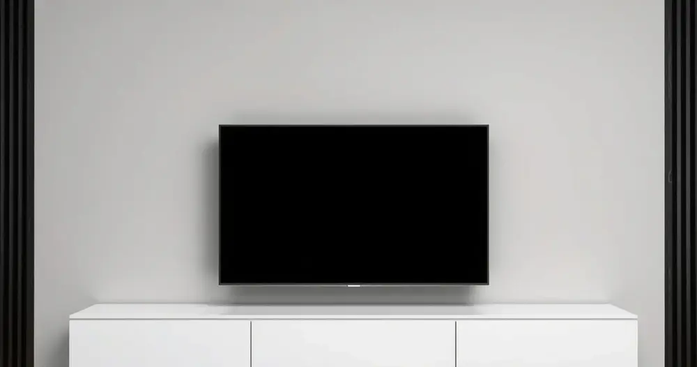 televisão de tela plana fixada na parede acima de armário branco baixo